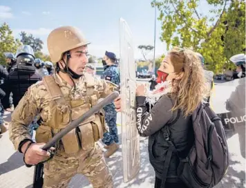  ?? HASSAN AMMAR/AP ?? A soldier scuffles with a demonstrat­or Monday in Beirut outside a military court where hundreds of protesters demanded the release of anti-government activists who were detained after riots in northern Lebanon late last month.