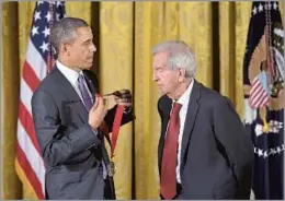  ?? Mandel Ngan AFP/Getty Images ?? RE-IMAGINING THE WEST McMurtry, receiving the National Humanities Medal from President Obama in 2014, had works that extended far beyond the tropes of Western literature.