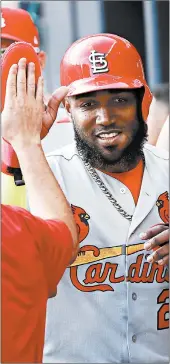  ?? JOHN BAZEMORE/AP ?? Marcell Ozuna is greeted by the Cardinals’ dugout during the first inning Wednesday.