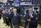  ?? RICHARD DREW — THE ASSOCIATED PRESS ?? Traders on the floor of the New York Stock Exchange, Tuesday observe a moment of silence in the wake of the attack in Manchester, England.