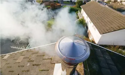  ?? Photograph: Global Warming Images/Alamy ?? A household chimney emitting smoke.