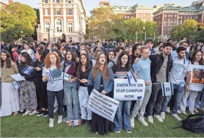  ?? YUKI IWAMURA/AP ?? Pro-Israel demonstrat­ors sing a song during a protest Thursday at Columbia University in New York. The campus was closed Thursday as a safety measure as hundreds attended dueling pro-Israeli and pro-Palestinia­n rallies.