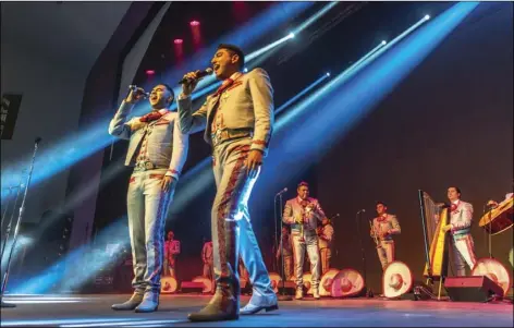  ?? PHOTO VINCENT OSUNA ?? Mariachi Sol de México de José Hernández singers Roberto Lopez (left) and Gustavo Pena perform during Mariachi Sol de México’s Merry-Achi Christmas concert held Wednesday night at Jimmie Cannon Theater in El Centro.