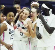  ?? David Butler II / Associated Press ?? UConn’s Nika Muhl, center right, hugs Paige Bueckers after defeating South Carolina on Feb. 8.