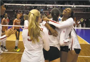  ?? D. Ross Cameron / Special to The Chronicle ?? Stanford’s Tami Alade, right, celebrates with her teammates, as the Cardinal defeated Texas in straight sets to advance to the NCAA semifinals for the 21st time in program history. The contest was a rematch of last year’s national final.