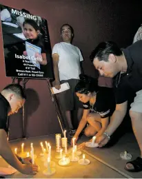  ?? BENJIE SANDERS/ARIZONA DAILY STAR FILE PHOTO ?? People place their candles at a poster of missing 6-year-old Isabel Celis in 2012 during a candleligh­t vigil in Tucson, Ariz., Tucson police Chief Chris Magnus says remains found in a remote area in Pima County about a month ago are those of Celis, who...