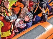  ??  ?? This file photo shows refugees after being rescued from a boat in the Mediterran­ean Sea on June 15, 2017