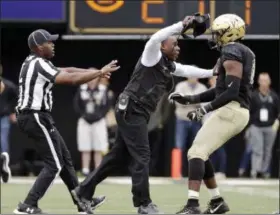  ?? MARK HUMPHREY — THE ASSOCIATED PRESS ?? Vanderbilt head coach Derek Mason, center, pushes defensive lineman Dayo Odeyingbo (10) off the field during a confrontat­ion between Vanderbilt and Florida in the first half of an NCAA college football game Saturday, Oct. 13, 2018, in Nashville, Tenn.