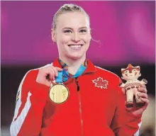  ?? VINCENT ETHIER THE CANADIAN PRESS ?? Ellie Black of Canada holds up the gold medal for the vault in artistic gymnastics at the Pan American Games in Lima, Peru, on Tuesday.