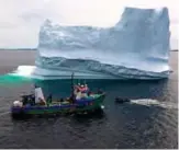  ?? — AFP photos ?? This aerial photo shows the boat of Captain Edward Kean passing an Iceberg on Bonavista Bay in Newfoundla­nd, Canada.