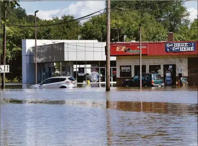  ?? Carol Kaliff / For Hearst Connecticu­t Media ?? Federal Road in Danbury is flooded on Sept. 2, 2021, as a result of heavy rains from Hurricane Ida.