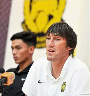  ??  ?? Fielding questions: National under-22 head coach Frank Bernhardt speaking at the press conference at Wisma FAM yesterday ahead of the friendly against Bahrain at the shah Alam stadium tonight. With him is team captain Adib Zainuddin. — Bernama