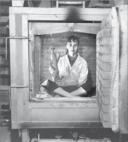  ?? Bernard Judge ?? CERAMIC ARTIST Dora De Larios in her kiln at USC in the late 1950s. Mexican American students like her were rare on campus.
