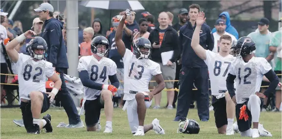 ?? PHOTOS: NAM Y. HUH/THE ASSOCIATED PRESS ?? Chicago Bears players warm up during training camp in Bourbonnai­s, Ill., on Saturday. Baltimore also kicked off its camp this week.