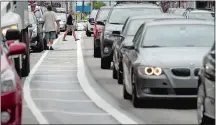  ?? TIM COOK/THE DAY ?? Pedestrian­s cross Bank Street in New London on Thursday afternoon as traffic negotiates the new one-lane traffic pattern. Go to theday.com to watch a video.