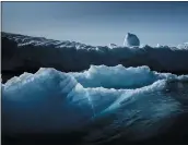  ?? THE NEW YORK TIMES ?? An iceberg is shown near Narsaq, Greenland. The warming at the top of the globe is causing its ice sheet to melt faster, researcher­s said.