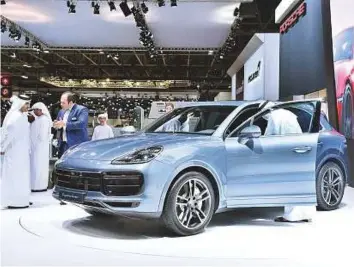  ?? Clint Egbert/Gulf News ?? The Porsche Cayenne Turbo appears to a be a popular attraction for people visiting the Dubai Internatio­nal Motor Show taking place at the Dubai World Trade Centre.