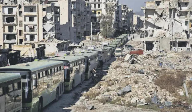  ?? PICTURE: GETTY IMAGES ?? 0 Buses line up to evacuate rebel fighters and their families from the embattled city of Aleppo yesterday
