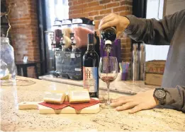  ?? JANETHERES­E PHOTOS/SPECIALTOT­HE MORNING CALL ?? Manager Chris Vespaziani pours a glass of 2016 Chambourci­n red wine, along with local smoked cheese at Black River Wine Bar inside the Trolley Barn Public Market in Quakertown on Nov. 11.