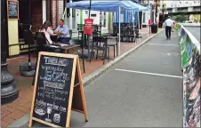  ??  ?? Diners eat at Tablao along Washington Street in Norwalk on Thursday.