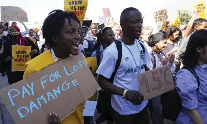  ?? Photograph: Peter Dejong/AP ?? A Fridays for Future protester at the Cop27 UN Climate Summit holds a sign calling for the “loss and damage” deal.