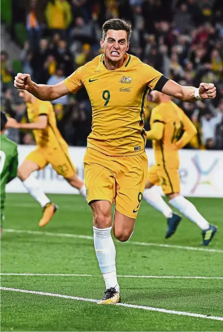  ??  ?? Australia’s Tomi Juric celebrates after scoring against Thailand during the World Cup qualifying Group B match in Melbourne yesterday. Australia won 2-1. — AP Right on target: