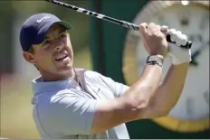  ?? ?? LEFT PHOTO: Rory McIlroy hits a drive on the 13th hole at The Country Club in Brookline, Mass., during a practice round ahead of the U.S. Open on Tuesday.