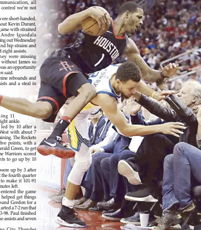  ??  ?? Houston Rockets’ Trevor Ariza collides with Golden State Warriors’ Stephen Curry as recording artist Usher, right, extends his arms during the second half of their game in Houston.