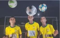  ??  ?? Saints football players Ephraim Musombwa, Samuel Irankunda, and Pacifique Mukunzi train at Endeavour Park.