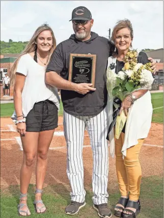  ??  ?? CHS Baseball head coach Chip Henderson poses for a photo with his wife, Cheryl, and daughter Carlie, on Thursday, April 18. Not pictured is Henderson’s other daughter, Cassie.