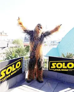  ??  ?? A person dressed up as Chewbacca character poses during a photocall to promote the new Star Wars Movie ‘Solo: A Star Wars Story’ in Berlin, Germany, May 4.