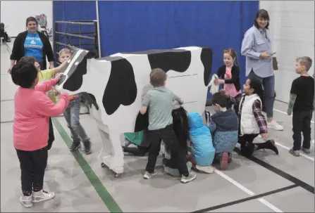  ?? Photo by Matthew Liebenberg/Prairie Post ?? DISCOVERY DAY: Kindergart­en students from Central School checks out the milking cow model at during the 11th annual Discover the Farm: A Farm Facts Experience and the Progressiv­e Agricultur­e Safety Day at Kinetic Park in Swift Current, April 27-28. For more on the event please see page 3.