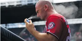  ?? KEVIN LILES/GETTY IMAGES ?? Clint Robinson of the Washington Nationals sprays sunscreen on his face prior to a Major League Baseball game.