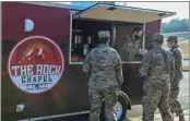  ?? AIRMAN 1ST CLASS MARIAM K. SPRINGS/U.S. AIR FORCE ?? U.S. Air Force Maj. Jeremy Caudill, 19th Airlift Wing deputy chaplain, serves coffee to airmen from a mobile coffee cart at the Little Rock Air Force Base on Dec. 17. While the cart delivers coffee beverages, it’s being used as an innovative means to further connection­s with the men and women of the base, reinforcin­g the chapel’s commitment to strengthen spiritual wellness and resiliency across the installati­on by any means necessary.