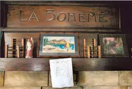  ??  ?? THE MANTEL in the Arts and Crafts home carries the inscriptio­n “La Boheme.” Hillary Danner and her father, Harry, a tenor, had performed in the opera.
