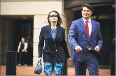  ?? Al Drago / Bloomberg ?? Kathleen Manafort, wife of former Donald Trump campaign manager Paul Manafort, left, exits District Court in Alexandria, Va., on Friday. Trump declined to comment Friday on whether he'll pardon Manafort, whose fate is in the hands of jurors deliberati­ng an 18-count indictment for a second day.