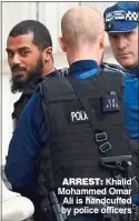  ??  ?? ARREST: Khalid Mohammed Omar Ali is handcuffed by police officers