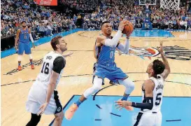  ?? BY BRYAN TERRY, THE OKLAHOMAN] [PHOTO ?? Oklahoma City’s Russell Westbrook goes to the basket between San Antonio’s Pau Gasol (16) and Dejounte Murray (5) during Saturday’s game at Chesapeake Energy Arena.