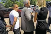  ?? ANDREW OXFORD/NEW MEXICAN FILE PHOTO ?? Sergio Muterperl, second from left, walks to a squad car with officers and his attorney in June 2016 after surrenderi­ng at the Santa Fe Police Department.