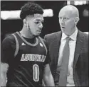  ?? MARK ZALESKI/AP ?? Louisville head coach Chris Mack, right, talks with G Lamarr Kimble on Friday.