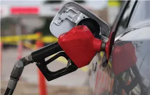  ?? The Associated Press ?? A motorist fills up the tank of a sedan on July 22 in Saratoga, Wyo. Gasoline prices have dipped under $4 for the first time in more than five months — good news for consumers who are struggling with high prices for many other essentials.