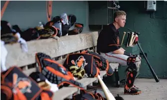  ?? LLOYD FOX/BALTIMORE SUN ?? Orioles catcher Chance Sisco sits in the dugout during an intrasquad game in February in Sarasota, Fla. Sisco took to the position as a high school senior before the Orioles selected him in the second round of the 2013 draft.