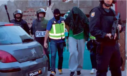  ?? AFP ?? A person is arrested by Spanish National police in Melilla during an operation against militants on Wednesday. —