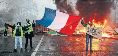  ?? ABDULMONAM EASSA AFP/GETTY IMAGES ?? The gilets jaunes, or yellow vests, movement started as a protest against higher fuel taxes, but it has become a rallying cry against French President Emmanuel Macron’s economic policies.