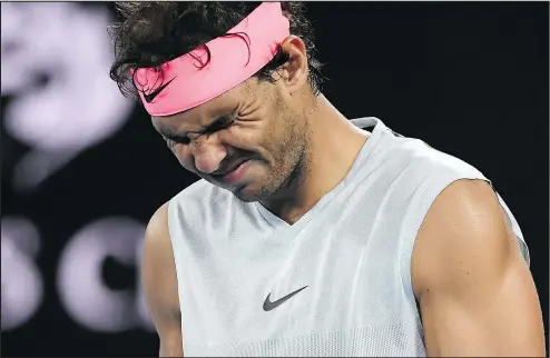  ?? GETTY IMAGES ?? Spain’s Rafael Nadal grimaces in pain as he walks onto the court while preparing to serve to Croatia’s Marin Cilic during their quarterfin­al match yesterday at the Australian Open in Melbourne. Nadal, the world No. 1, retired with a leg injury.