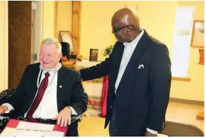  ?? (Arkansas Democrat-Gazette file) ?? Simmons Foundation CEO Tommy May (left) spoke about the Go Forward Pine Bluff plan at various community town hall meetings and during a City Council meeting in early 2017.