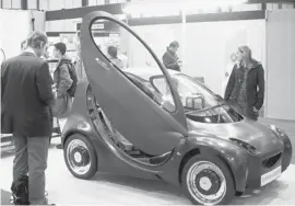  ?? Max Nash/afp/getty Images ?? Visitors view the British Riversimpl­e Hydrogen Fuel Cell car at the British Invention Show in Alexandra Palace in north London in 2009.