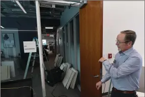  ?? (NWA Democrat-Gazette/Andy Shupe) ?? David Johnson, director of the Fayettevil­le Public Library, shows smoke damage Monday in the library’s administra­tive offices after a fire Sunday night damaged the library building necessitat­ing its closure Monday.