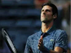  ?? JASON DECROW — THE ASSOCIATED PRESS ?? Novak Djokovic, of Serbia, walks onto the court for the opening coin toss of his match against Tennys Sandgren, of the United States, during the second round of the U.S. Open tennis tournament Thursday in New York.