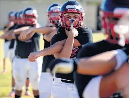  ??  ?? Players stretch before practice at Norte Vista High School in Riverside on Tuesday.